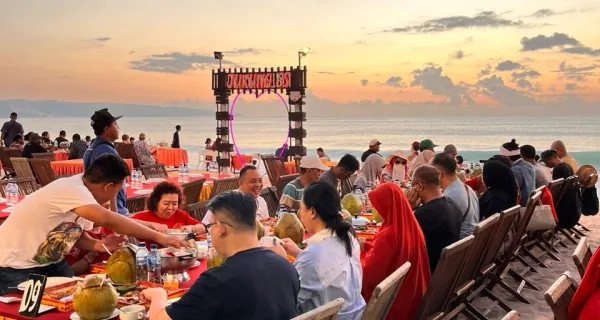 Outdoor dinner tables on Jimbaran Beach in Bali.