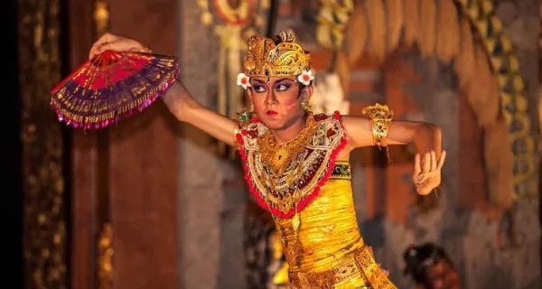 A Balinese Legong dancer performing in traditional costume.